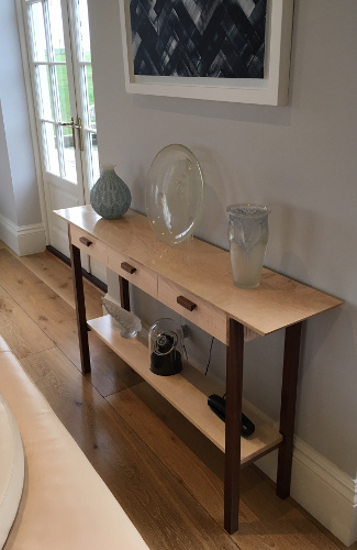 a console table with three drawers, narrow wood table with drawers handmade from solid wood pictured in tiger maple and walnut